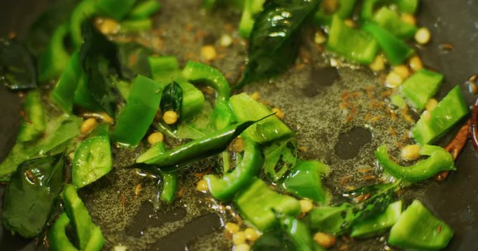 Slow motion shot of cooking a simple and easy vegetarian curry.