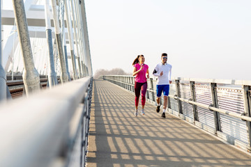 Couple jogging at the bridge