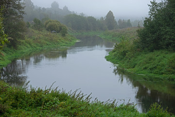 landscape of a midland of Russia in the fall - the river, fog...