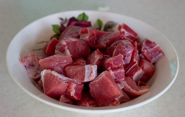 Finely chopped meat on a plate. Finely chopped raw meat in a plate. Finely chopped raw meat in a white plate. Finely chopped raw meat. Finely chopped raw beef. Finely chopped raw beef in a plate