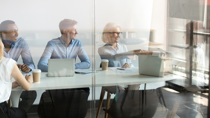 Diverse businesswomen handshake closing deal at meeting