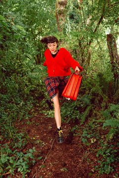 Young woman running in forest