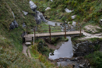 Fototapeta na wymiar Wooden footbridge over river in Cornwall
