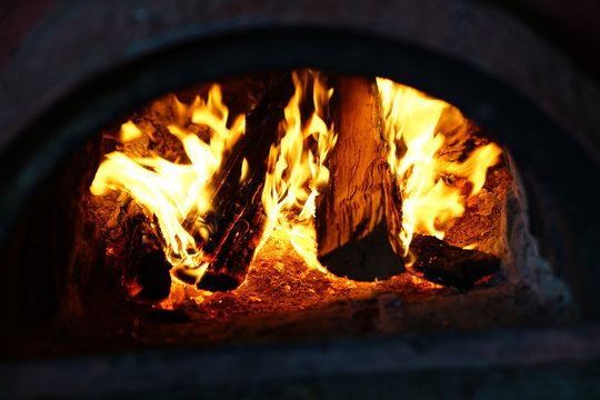Hot bright burning fire with in oven in darkness