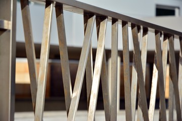 Chromium metal fence with handrail. Chrome-plated metal railings. Shallow depth of field. Selective focus.