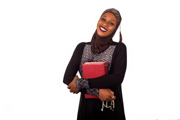 portrait of young muslim woman standing with a book