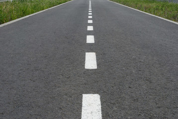 Dark asphalt road with marking lines. Tarmac texture