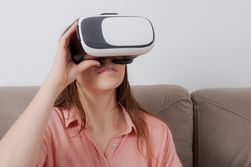 Beautiful woman looking with VR device and feeling excited.