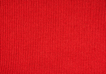 Christmas background from red knitted wool closeup