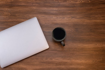 Top view workspace mockup, blank screen laptop, coffee mug on wood texture desk
