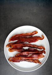 Cooked Bacon Stripes on Dark Background