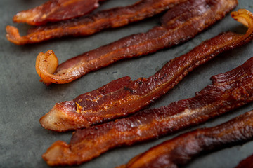 Cooked Bacon Stripes on Dark Background