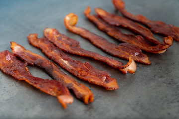 Cooked Bacon Stripes on Dark Background