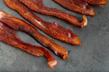 Cooked Bacon Stripes on Dark Background