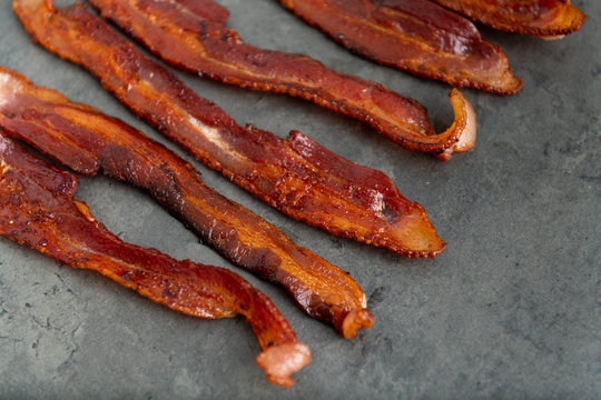 Cooked Bacon Stripes on Dark Background