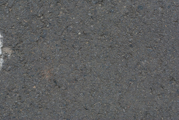 Smooth asphalt road. Tarmac dark grey grainy road background. Top view grunge rough surface