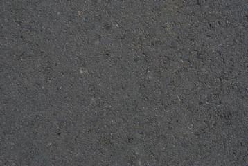 Smooth asphalt road. Tarmac dark grey grainy road background. Top view grunge rough surface