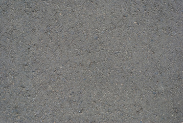 Smooth asphalt road. Tarmac dark grey grainy road background. Top view grunge rough surface