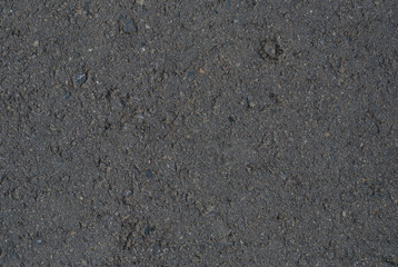 Smooth asphalt road. Tarmac dark grey grainy road background. Top view grunge rough surface