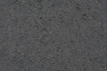 Smooth asphalt road. Tarmac dark grey grainy road background. Top view grunge rough surface
