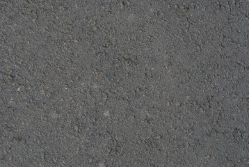 Smooth asphalt road. Tarmac dark grey grainy road background. Top view grunge rough surface