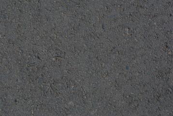 Smooth asphalt road. Tarmac dark grey grainy road background. Top view grunge rough surface