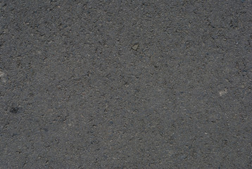Smooth asphalt road. Tarmac dark grey grainy road background. Top view grunge rough surface