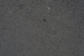 Smooth asphalt road. Tarmac dark grey grainy road background. Top view grunge rough surface