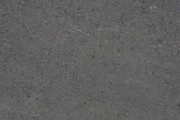 Smooth asphalt road. Tarmac dark grey grainy road background. Top view grunge rough surface