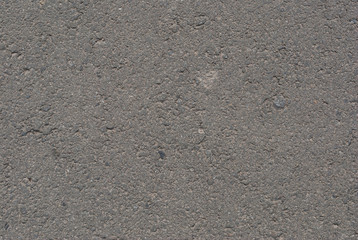 Smooth asphalt road. Tarmac dark grey grainy road background. Top view grunge rough surface