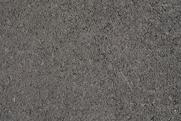 Smooth asphalt road. Tarmac dark grey grainy road background. Top view grunge rough surface