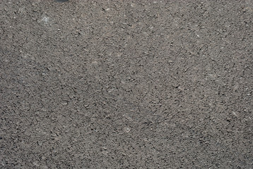 Smooth asphalt road. Tarmac dark grey grainy road background. Top view grunge rough surface