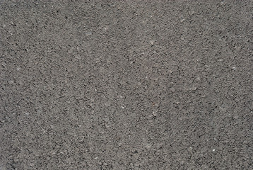 Smooth asphalt road. Tarmac dark grey grainy road background. Top view grunge rough surface