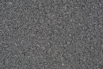 Smooth asphalt road. Tarmac dark grey grainy road background. Top view grunge rough surface