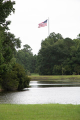 American flag beside pond water