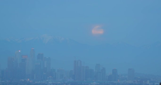 Full moon rising behind DTLA in Los Angeles, California