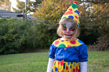 Little girl wearing scary clown costume