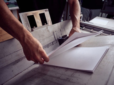 Unrecognizable employee using professional tools for book making