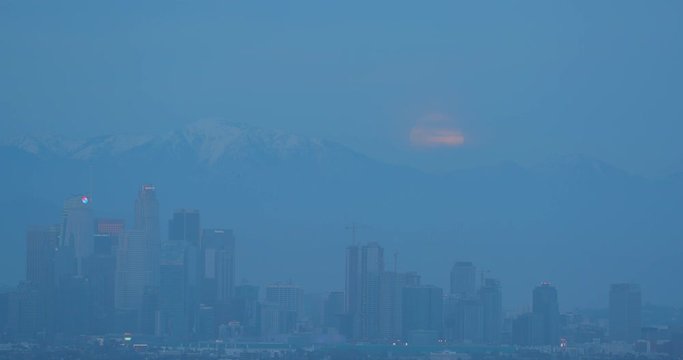 Full moon rising behind DTLA in Los Angeles, California