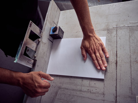 Unrecognizable employee using professional tools for book making