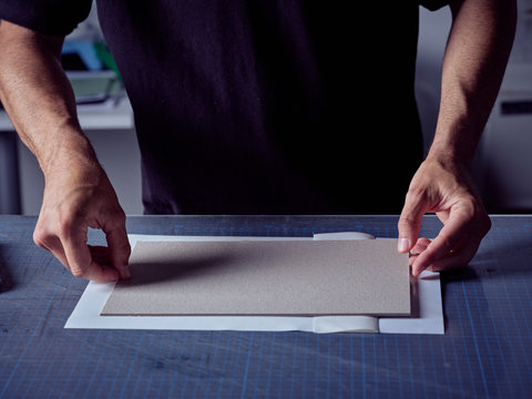 Bookmaker folding paper over cover board