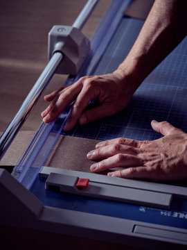 Professional bookmaker cutting paper with accurate equipment
