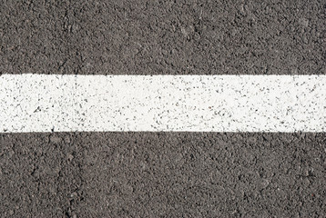 Asphalt texture with white line and tire marks . Top view