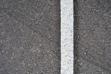 Asphalt texture with white line and tire marks . Top view