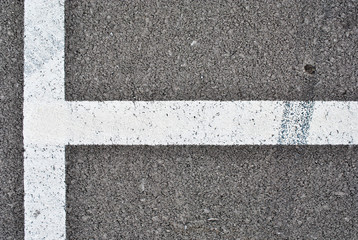 Asphalt texture with white line and tire marks . Top view