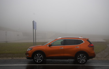 orange car on the road in mountains