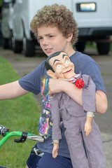 Young boy playing with ventriloquist dummy