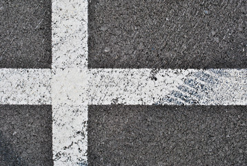 Fototapeta na wymiar Asphalt texture with white line and tire marks . Top view