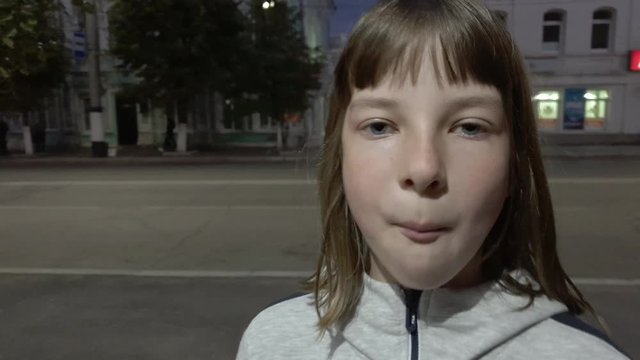 Beautiful teen girl inflating bubble of chewing gum. Moderm fashion girl.