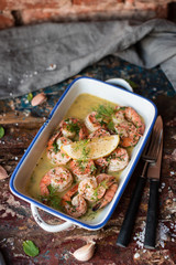 Lemon garlic butter shrimp on wooden background